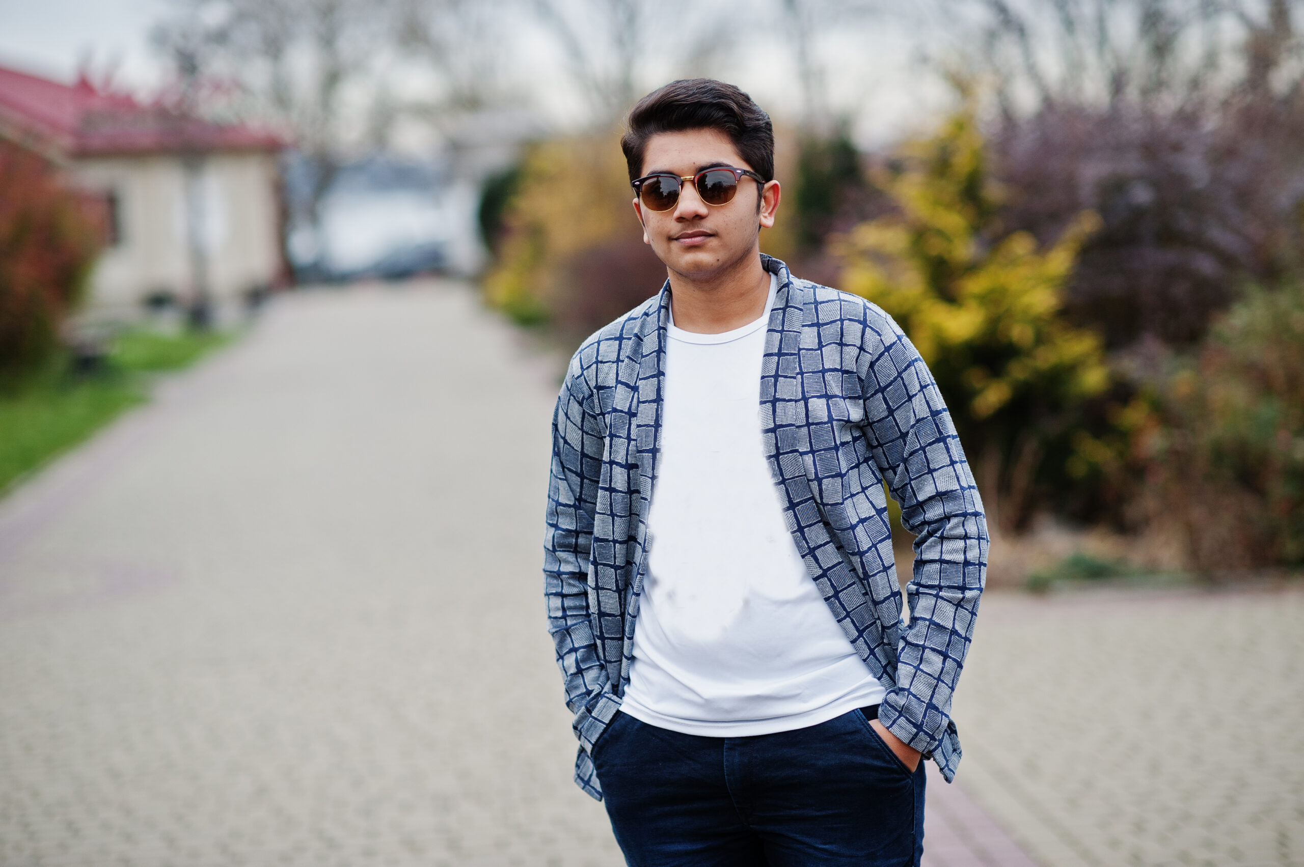 Stylish indian young man at sunglasses wear casual posed outdoor